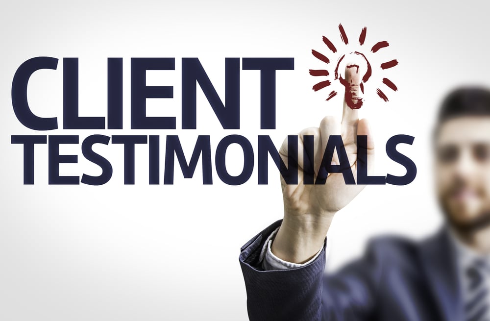 Business man pointing to transparent board with text Client Testimonials Business man pointing to transparent board with text Client Testimonials