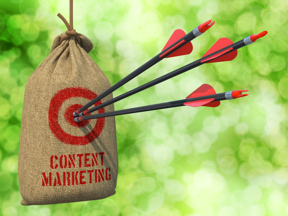Content Marketing - Three Arrows Hit in Red Target on a Hanging Sack on Natural Bokeh Background.
