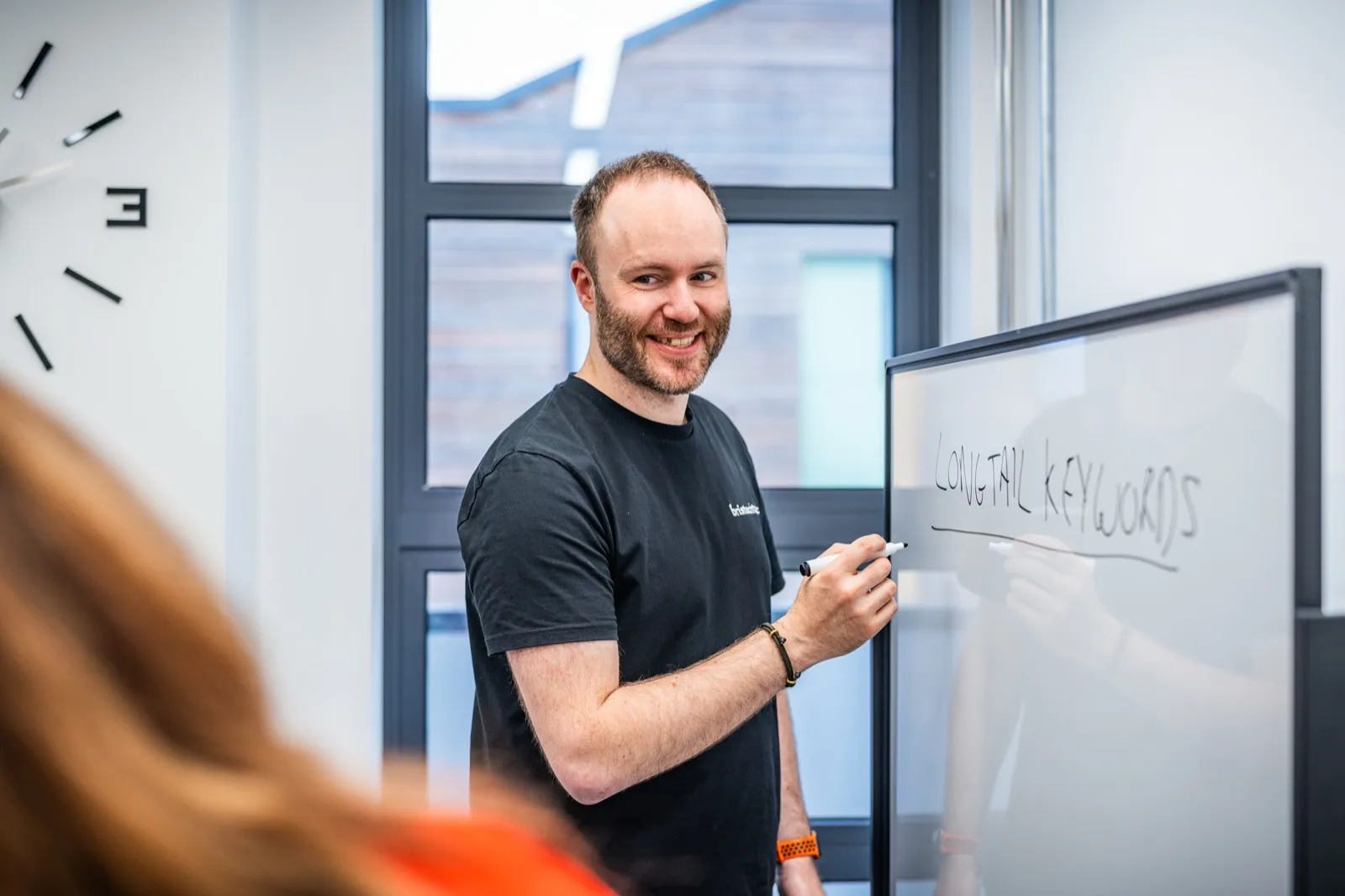 A BrisTechTonic strategist explaining an SEO plan at a whiteboard