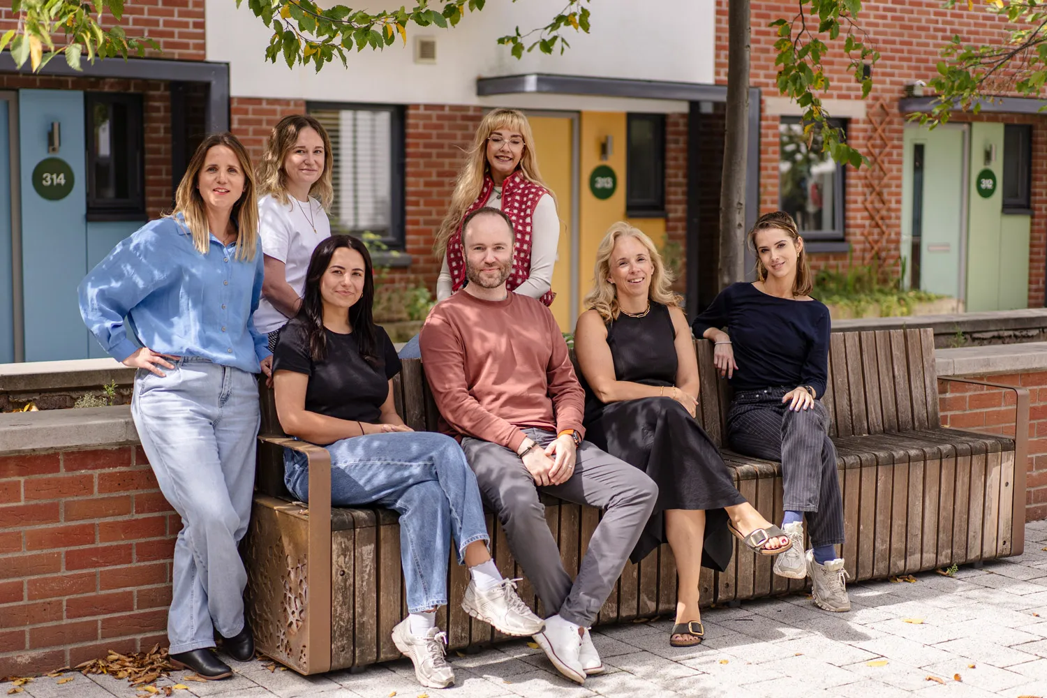 Team of SEO Experts at BrisTechTonic sitting outside on a bench.