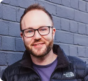 SEO specialist leaning against brick wall
