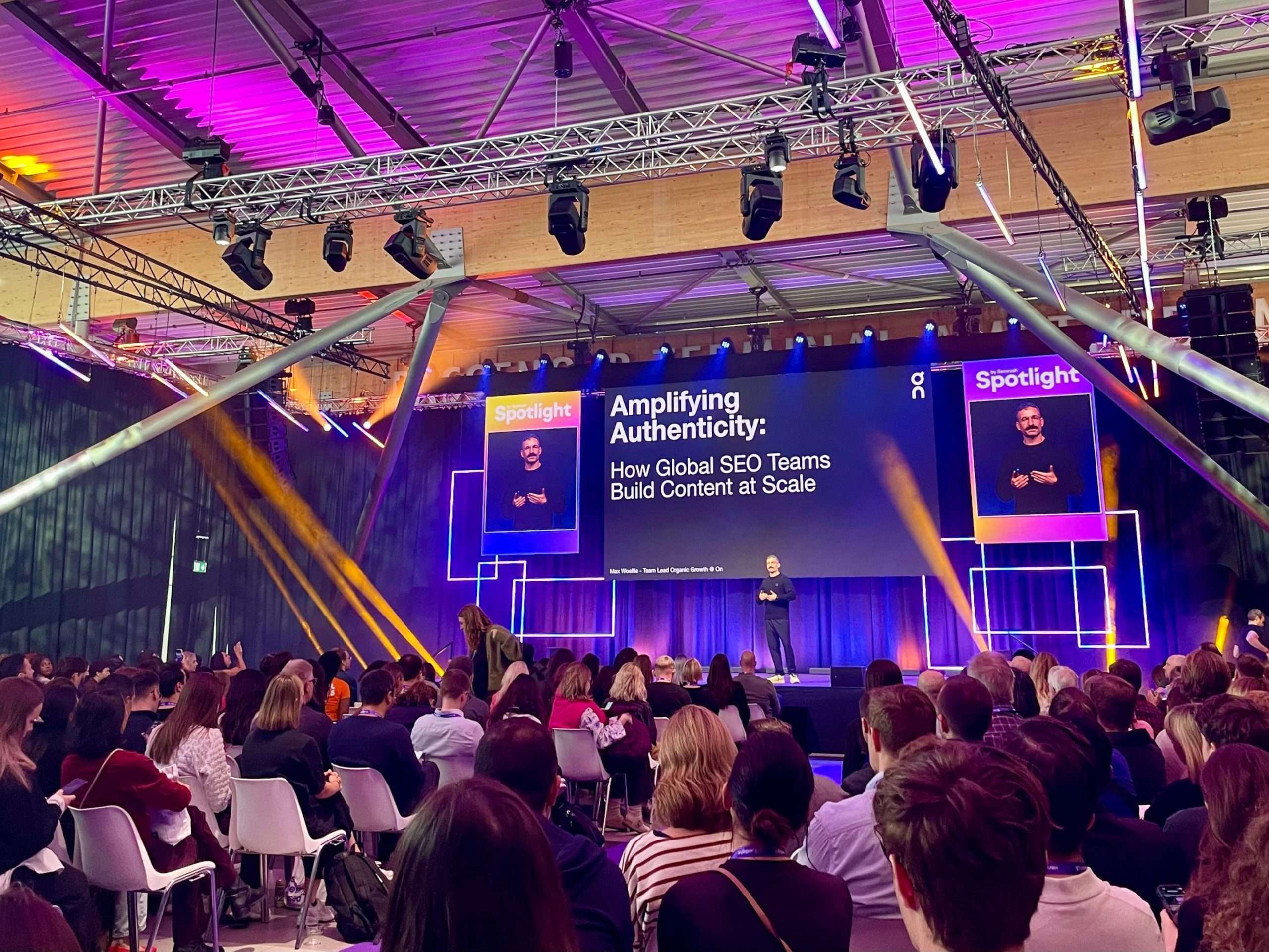 SEMrush speaker with screen that reads “Amplifying Authenticity: How Global SEO Teams Build Content at Scale”
