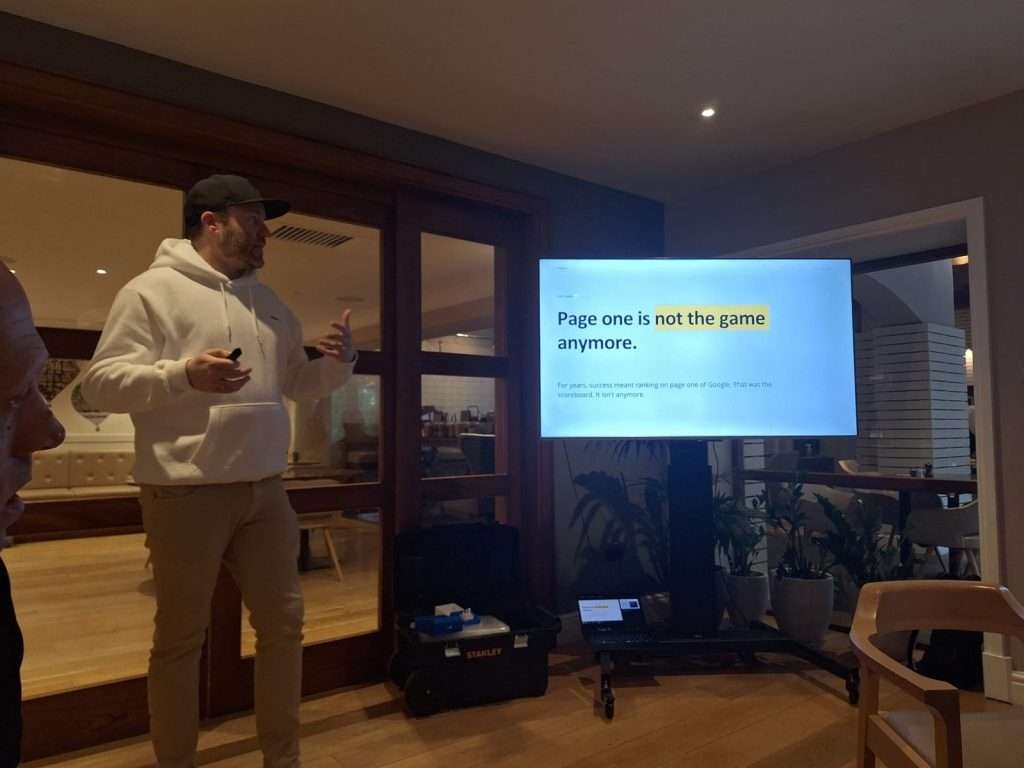 Chris McDowell speaking at BNI Hadlee with the Page One slide on screen