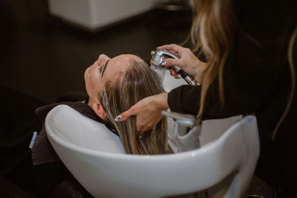 Hair salon stylist cutting client hair