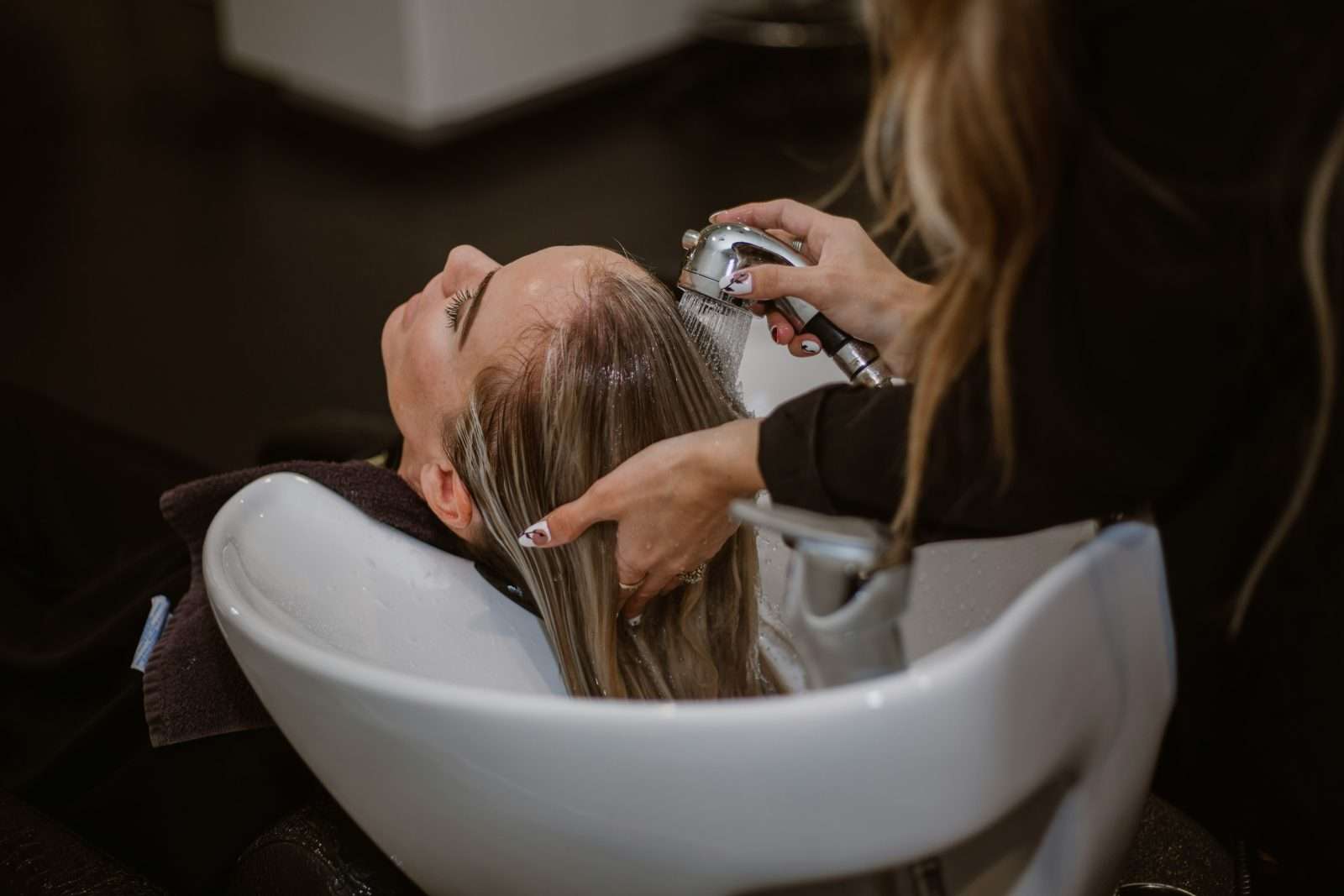 Hair salon stylist cutting client hair
