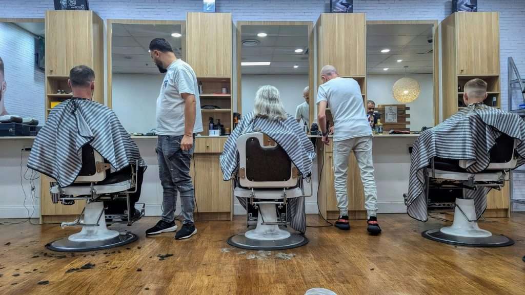 Barbers cutting hair in a modern salon