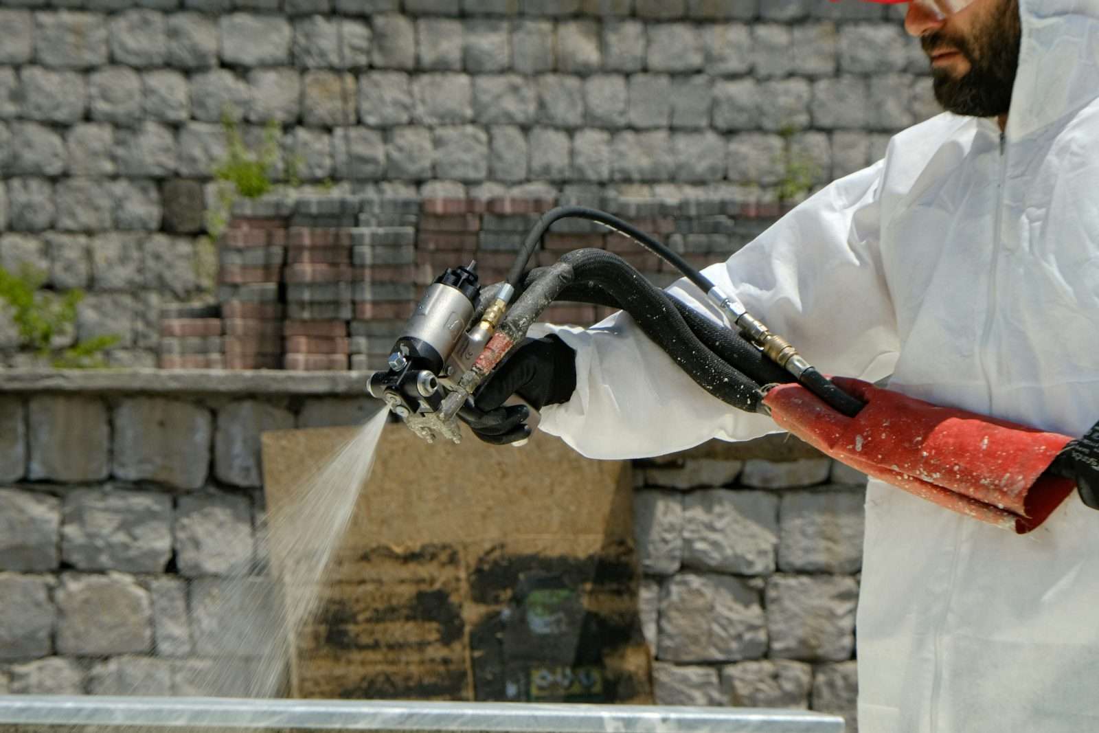 UK asbestos removal specialist in white coverall PPE
