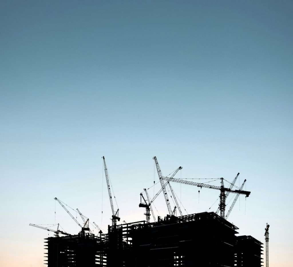 Construction, silhouette of cranes on a building site